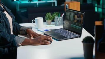 Professional editor analyzing film montage before editing color grading and lighting in creative office. Post production studio employee working with raw footage, improving quality, camera A video