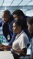 Vertical Team of data center technicians maintaining company network infrastructure by configuring and troubleshooting hardware. Teamworking server hub colleagues ensuring optimal system performance, camera A video