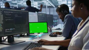 Data center programmer using mockup tablet, maintaining company network infrastructure, close up. Server hub worker ensuring optimal system performance with isolated screen device, camera A video