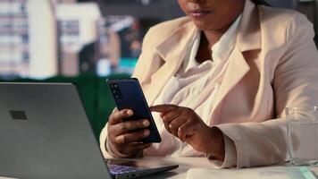 Black entrepreneur discussing about updates or business ideas with her staff, shares project insight via text messages on internet connection. Successful goal oriented black CEO. Camera A. video
