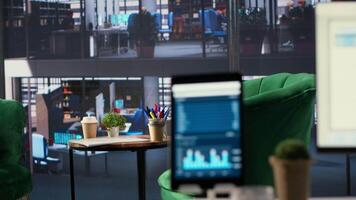 Modern office space with financial data on a monitor used for meetings, running detailed analytics and graphs. Empty workspace to develop business strategies for success, productivity tools. video