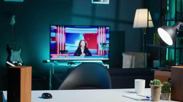 Woman arriving in apartment office, sitting down at desk, opening laptop to begin doing tasks. Teleworker starting job shift at home, preparing notebook device, logging in online, camera A video