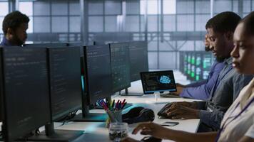 Computer scientists in data center implementing AI predictive maintenance systems. Server farm employees using artificial intelligence to identify hardware failures impacting operations, camera A video