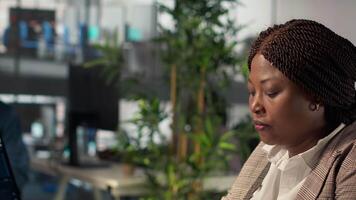 African american team members engaged in administrative tasks with archived files, reviewing data reports and corporate analytics to ensure alignment with enterprise goals for success. Camera A. video