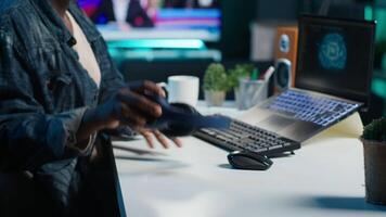 Programmer in living room office typing on keyboard, updating artificial intelligence neural networks, writing binary code scripts. Freelancing system administrator upgrading high tech AI, camera A video