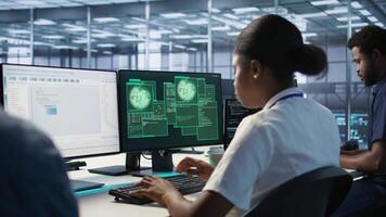 Woman seeing critical error on PC screen in data center, requesting help from cybersecurity team. Employee seeing security incidents affecting server room network system, camera A video