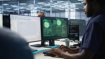 Cybersecurity division workers in server room protecting equipment from hacker stealing data. Data center IT specialists struggling to delete virus attacking company servers, doing brainstorming video