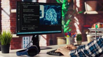 Freelancing computer engineer doing maintenance on artificial intelligence systems, closeup. Remote tech support specialist at working from home, doing checkup on AI systems, camera B video