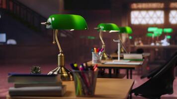 Peaceful empty library featuring wooden shelves and vintage green lamps. The classic architecture and serene study space inspire learning, literacy and intellectual growth. Old fashioned design. video