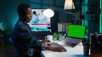 Teleworker in living room office using chroma key laptop to answer emails from business associates. Remote employee typing on isolated screen device keyboard, solving tasks in apartment video