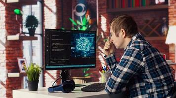 AI software developer at computer waiting for code to finish compiling, rubbing forehead with pen, feeling bored. Impatient man waits for artificial intelligence scripts to finish compiling, camera B video