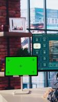Man in home office uses AI program turning text prompt into videos next to isolated screen tablet. Person using text to generative models on computer and chroma key device, camera A