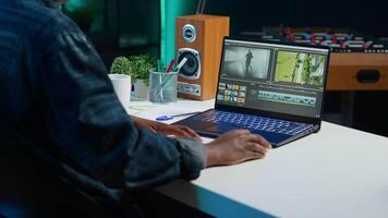 editor selecting key frames to use while doing montage, working from home on notebook device. Woman using mouse to edit movie project footage in apartment office, camera A video