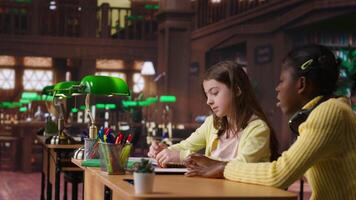 Teacher assisting scholars with class homework for mentoring session, providing academic instruction and support to help with the curriculum. Tutor lecturer gives private lessons. Camera B. video