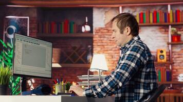 Coder at workstation programming on PC, writing lines of code, using development tools, feeling stressed. Man in home office having deadline, stressed to finish debugging software, camera B video