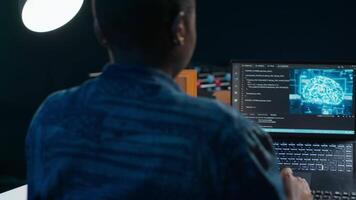 AI professional in home office using laptop to write programming language code. Artificial intelligence engineer working from home using notebook device to build application, camera A video
