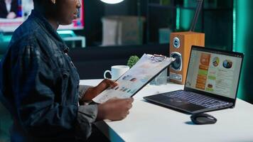 Self employed woman checking statistical data financial graphs on laptop screen, researching insights. Remote worker comparing business graphic economic figures, making strategy, camera A video