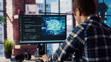 Developer writing code on computer and doing maintenance on artificial intelligence neural networks computerized model. Tech support expert typing on keyboard, doing checkup on AI systems, camera B video