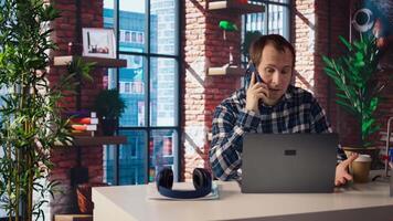 Manager at work arguing with employee during phone call after finding mistakes in spreadsheets on laptop. Team leader scolding worker during telephone call after finding errors in documents, camera A video