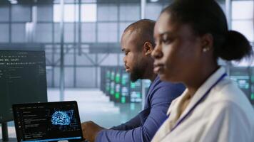 System administrators in data center implementing AI systems. Server farm specialists using artificial intelligence to identify hardware failures impacting operations, camera A handheld camera shot video
