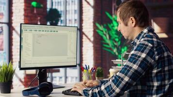 Software developer at computer coding, creating software, implementing algorithms. IT expert in home office working with code editor, building applications, optimizing performance, camera B video