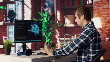 Admin using computer in home office for artificial intelligence computing simulating human brain through self learning algorithms. Employee working with AI deep neural networks on desktop PC, camera B video