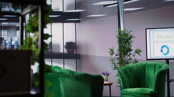 Empty office space showcases a monitor with financial data during meetings, running detailed infographics in a high end decorated workspace. Develop business strategies for success. video