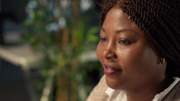 Black executive analyst finalizes financial report and reviews data, developing a forecast for organizational progress. Woman engaged in task management and strategy planning. Close up. Camera A. video