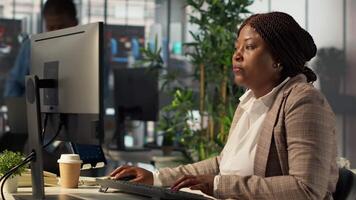 Team of business associates discuss about a project focused on financial growth, evaluating resource allocation and performance metrics. Black staff achieve objectives effectively. Camera A. video