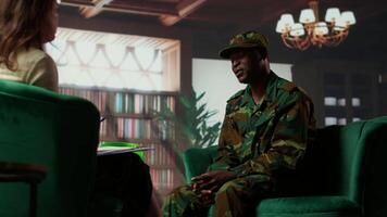 Anxious depressed private sharing his struggles with combat flashbacks, counseling session with psychiatrist for rehabilitation. Psychological support and reintegration for soldiers. Camera B. video