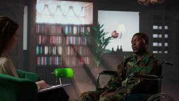 Black army soldier in wheelchair is a war survivor and deals with shell shock, experiencing a bad case of PTSD and anxiety. Wounded trooper opening up about horror combat scenes. Camera A. video