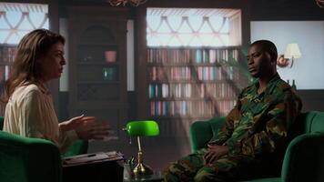 African american military trooper sharing flashbacks from the war during counseling session, tying to cure PTSD and shell shock. Army veteran deals with depression after traumatic scenes. Camera A. video