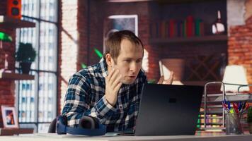 Manager calls employee remotely using internet videocall to offer negative feedback on project progress. Angry team leader berating teleworker at home in teleconference meeting, camera B video