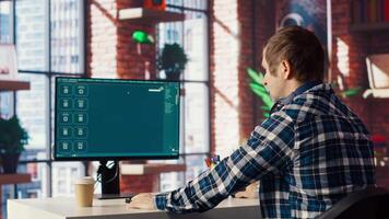 Graphic designer designing UX for AI software turning text prompt into photos. IT specialist in home office using machine learning tech to build text to image models, camera B video