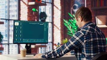 Man requesting help from text to image GPT software in modern home office, turning prompts into photos. Person in brick wall home office using PC get help for tasks from text to image AI, camera B video