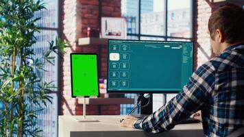 Man looking at tutorial on green screen tablet to learn how to use text to generative models. Man in home office watching guide on mockup device about AI program, camera B video