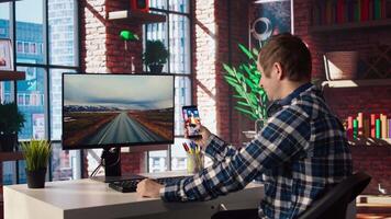Man at home watching social media live broadcasts, interacting in chat with online content creators. Person holding phone, using social network app to partake in livestreams, camera A video