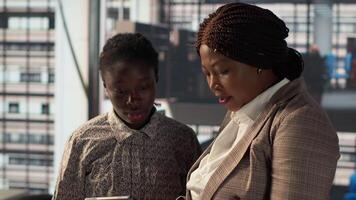 Businesspeople colleagues strategize a plan at a modern workplace, focusing on company goals by developing a sustainable enterprise strategy to achieve corporate success and objectives. Camera A. video
