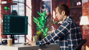 Man having fun interacting with AI LLM chatbot PC GPT software on PC in modern home office. User using large language model application communicating through artificial intelligence, camera B video