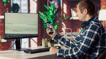 Man in home office looking at social media feed with live broadcasts from online content creators. Employee at work using social network application with livestreams done by influencers, camera B video