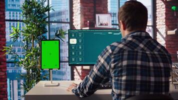 Man looking at tutorial on green screen tablet to learn how to use text to generative models. Man in home office watching guide on mockup device about AI program, camera A video