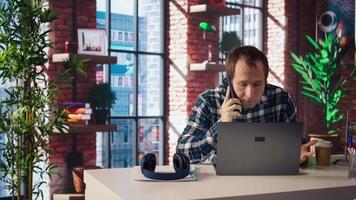 Manager in home office sitting at desk in front of laptop, calling employee to confront him about mistakes. Supervisor using notebook to do job online, doing telephone call to scold worker, camera A video