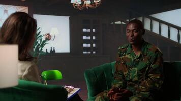 Black distraught war veteran crying due to shell shock and combat flashbacks, cure his anxiety after traumatic experiences. Army soldier dealing with a mental disorder during therapy. Camera A. video