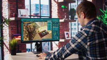 Architectural designer in home office moving assets in 3D modeling program, doing interior design project. Man looking at CAD software interface on PC, making home floor plans, camera A video