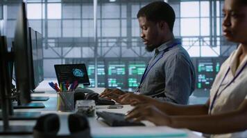 Data center engineers maintaining company network infrastructure by installing, configuring, troubleshooting and repairing hardware. Server hub workers ensuring optimal system performance, camera A video