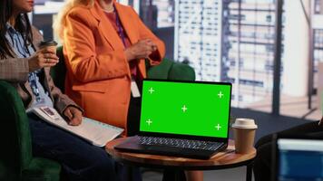 Multiethnic women discussing new strategies next to green screen, reviewing performance metrics and other data for evaluation. Group of leaders working in a men dominated environment. Camera A. video