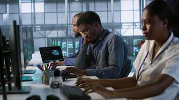 Tired data center engineer yawning, suffering from lack of sleep while maintaining company network infrastructure. Bored server hub worker feeling fatigued, struggling to stay awake, camera A video