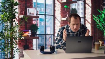 Manager calls employee remotely using internet videocall to offer negative feedback on project progress. Angry team leader berating teleworker at home in teleconference meeting, camera A video