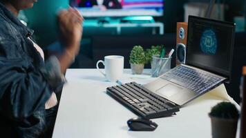 Data scientist using laptop, updating artificial intelligence machine learning algorithms, writing code scripts. Teleworking IT specialist in apartment office uses programming to upgrade AI, camera A video