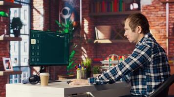 Man at home looking over documentation files to learn how to use text to generative models. Person in apartment reading technical specifications documents for AI program, camera B video